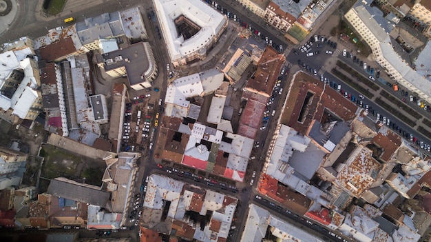 Rooftops of the old town in Lviv in Ukraine during the day. The magical atmosphere of the European city. Landmark, the city hall and the main square. Aerial view.