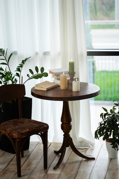 Room decor with potted plants and candles on wooden table