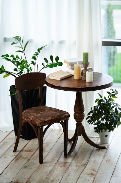 Room decor with potted plants and candles on wooden table