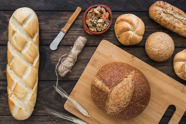 Rope and knife amidst bread and dessert