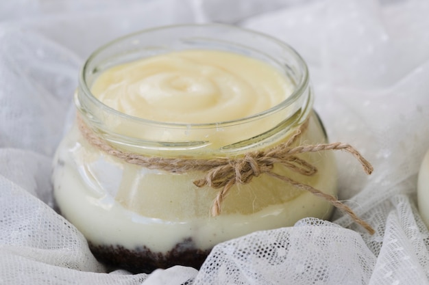 Free photo rope tied around the lemon curd jar over the white lace fabric