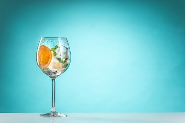 The rose exotic cocktail and fruit on blue background