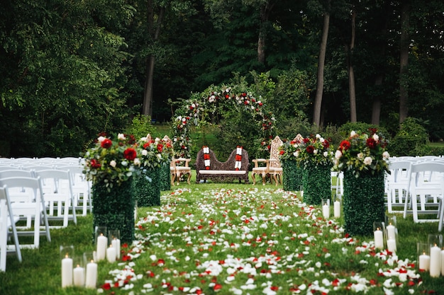 Rose petals cover green garden ready for traditional Hindu weddi