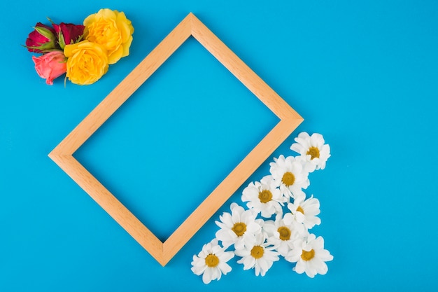 Roses and chamomiles near frame