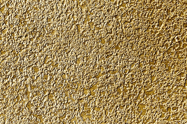 Free Photo roughly gold painted concrete wall surface background