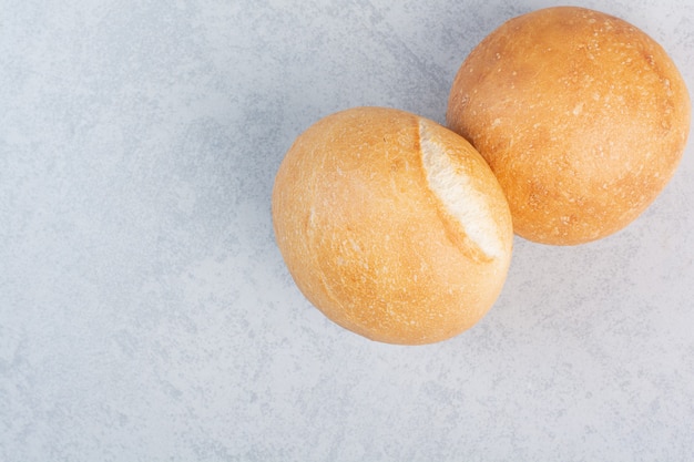 Free Photo round burger buns on stone surface