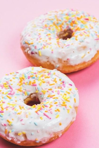 Free Photo round iced doughnuts topping with colorful decoration