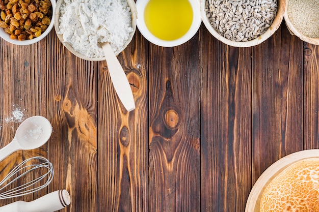 Free photo row of baking ingredients on wooden table