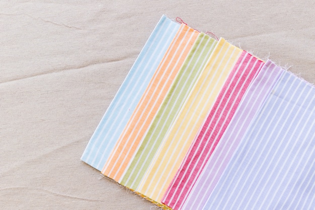 Free photo row of colorful stripes pattern curtain samples on textile surface