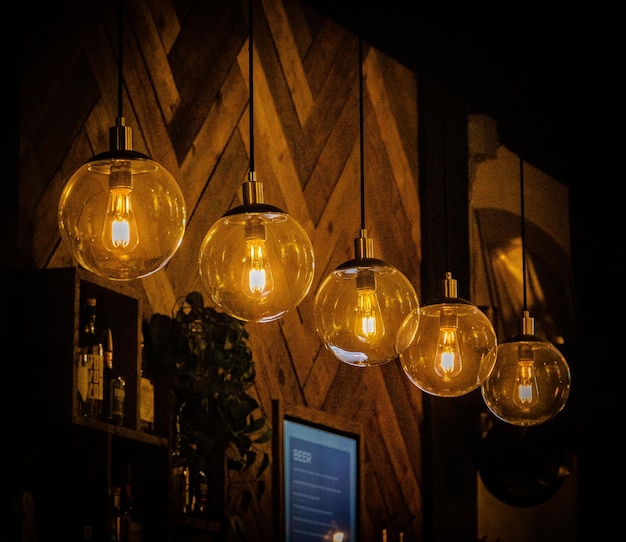 Free Photo row of decorative light bulbs hanging in a cafe