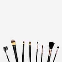 Free photo row of makeup brushes with copy space for writing the text on white background