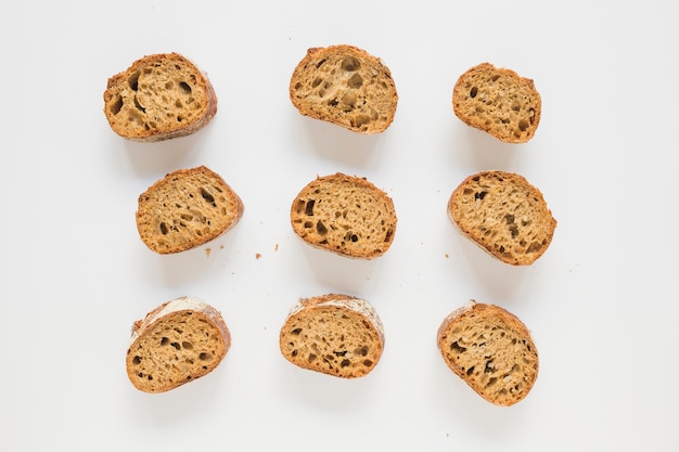 Free Photo row of toast bread on white backdrop