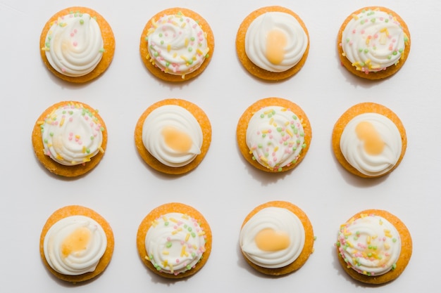 Row of whipped cupcake on white background