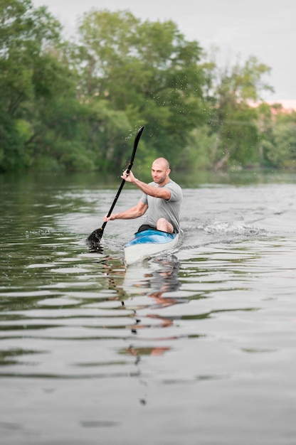 Rowing concept with man holding oar