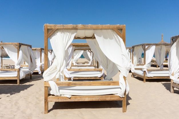 Free photo rows of wooden canopies at the beach