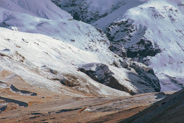 Rugged landscape of the rocky mountains covered with layers of snow