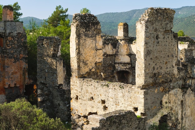 Free Photo ruins of the abandoned greek city of levissi near the village of kayakoy in fethiye turkey against the backdrop of cumulus clouds the tragedy of wars site of the ancient city of karmilissos