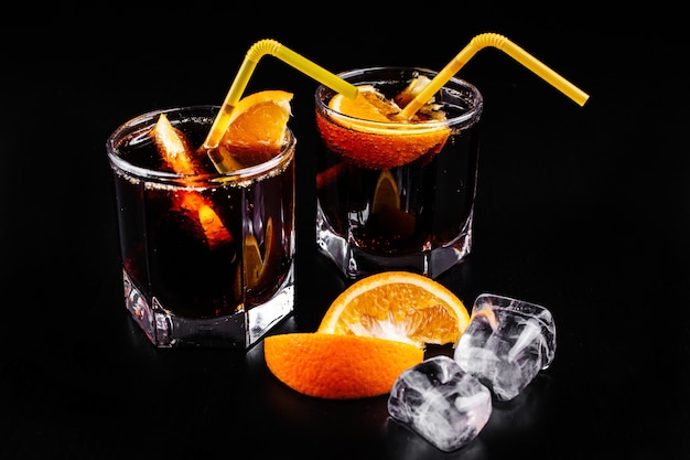 Free Photo rum and cola refreshing alcohol cocktail drink in highball glass with orange and ice