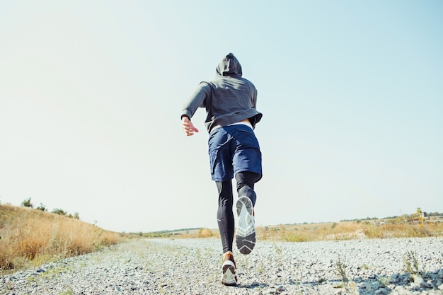 Running sport. Man runner sprinting outdoor in scenic nature.