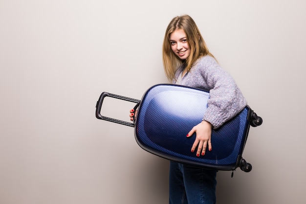 Free Photo running woman with suitcase. beautiful girl in motion. traveler with baggage isolated. traveling teen girl