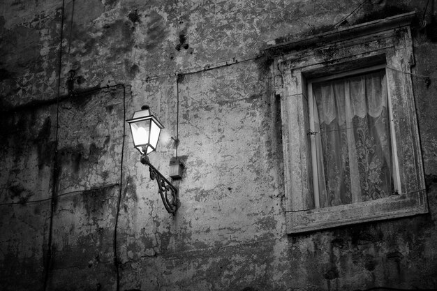 Rural wall with lamp in the night