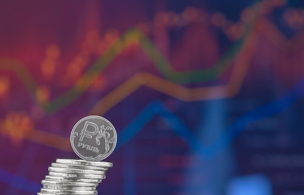 Free photo the russian ruble falls out of the column of coins against the background of the exchange rate chart economic sanctions and economic crisis space for text idea for banner and news