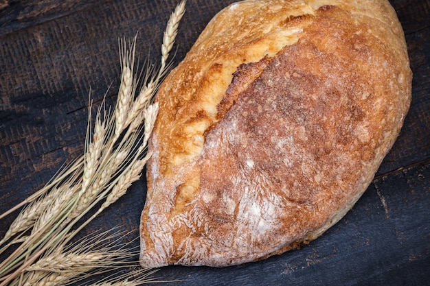 Rustic bread on wood table. Dark moody space with free text space.