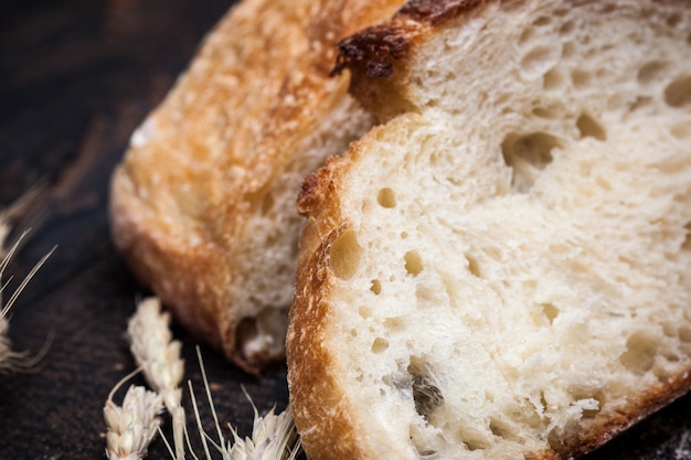 Rustic bread on wood table. Dark wooden space