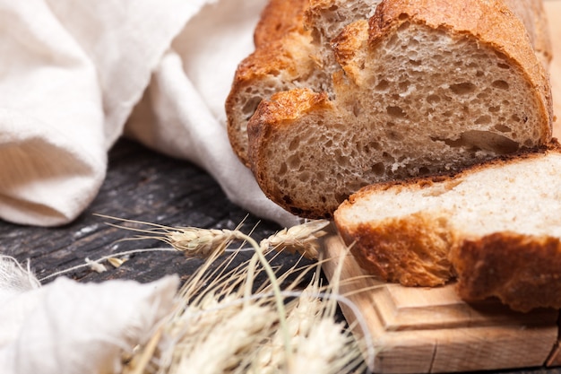 Rustic bread on wood table. Dark wooden space