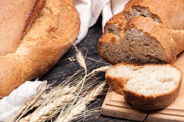 Rustic bread on wood table. Dark wooden