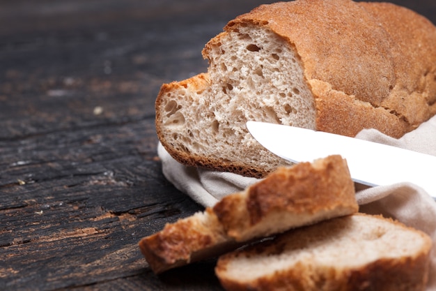 Rustic bread on wood table. Dark woody with free text space.