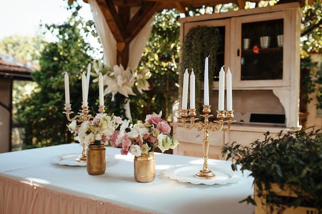 Rustic candlestick and flower arrangement on table at wedding reception.