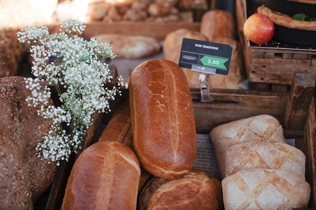 Rustic loaves baked bread with tag and gypsophila flowers