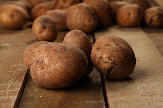 Rustic unpeeled potatoes on a desks