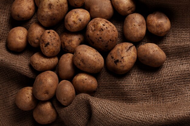 Rustic unpeeled potatoes on a desks