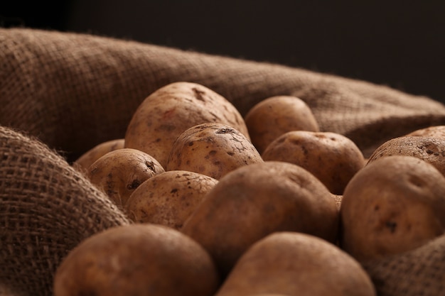 Rustic unpeeled potatoes on a desks