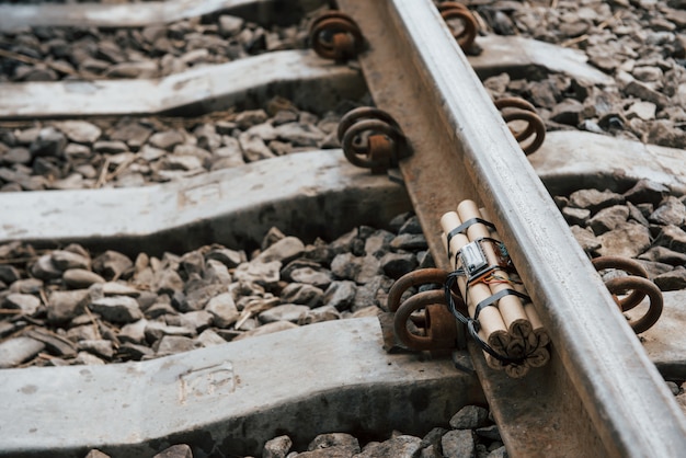 Rusty metal. Timebomb on the railway at daytime outdoors. Conception of terrorism and danger