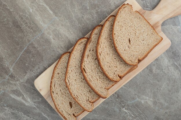 Rye bread slices on wooden board. High quality photo