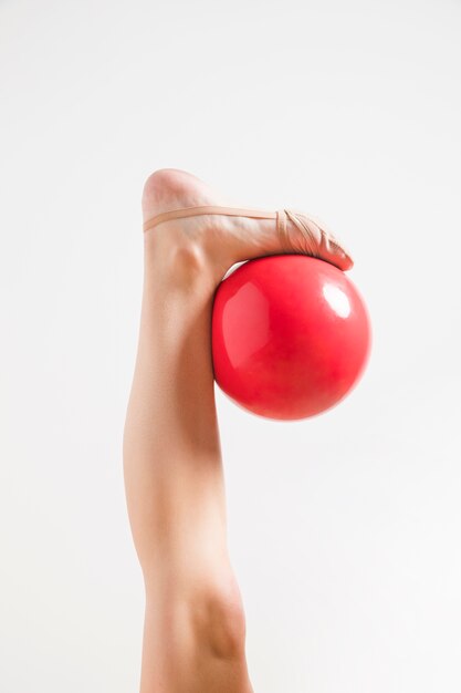 Rythmic gymnast posing with the ball