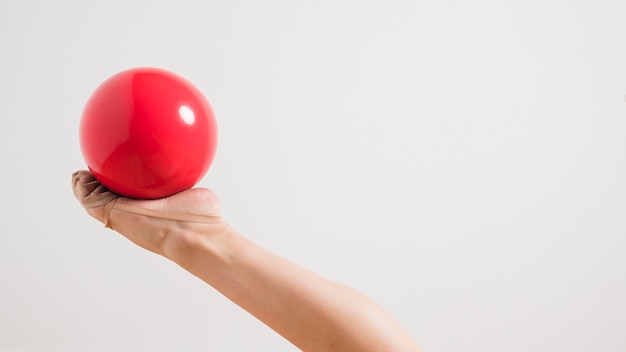 Rythmic gymnast posing with the ball