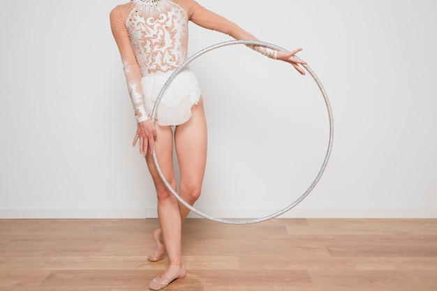 Rythmic gymnast posing with the hoop