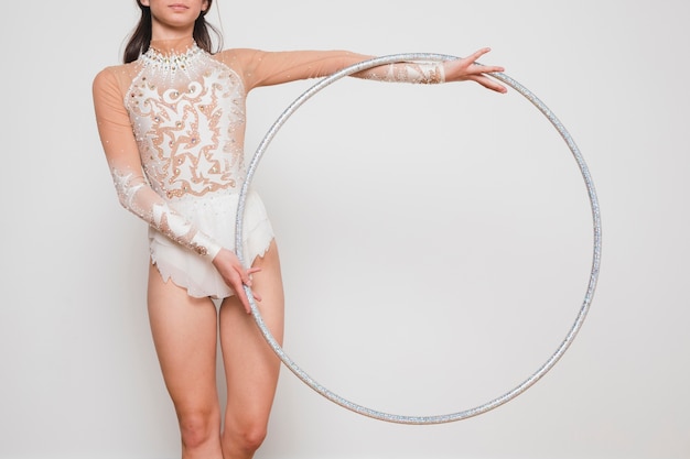 Free photo rythmic gymnast posing with the hoop