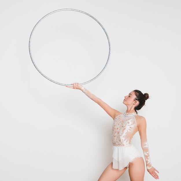 Rythmic gymnast posing with the hoop