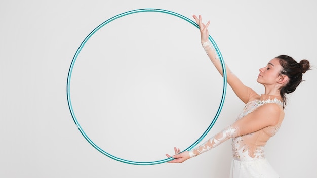 Rythmic gymnast posing with the hoop