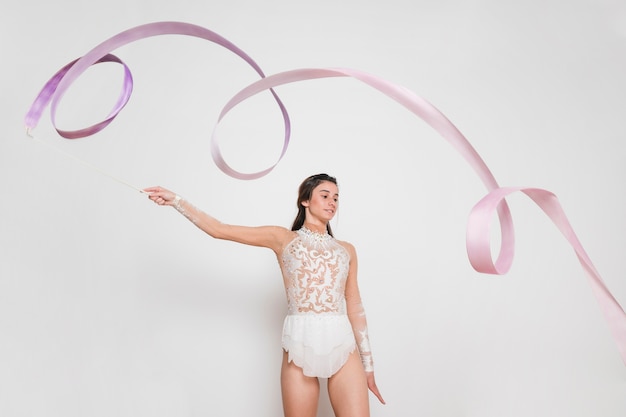 Rythmic gymnast posing with the ribbon