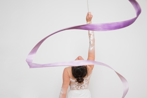 Rythmic gymnast posing with the ribbon