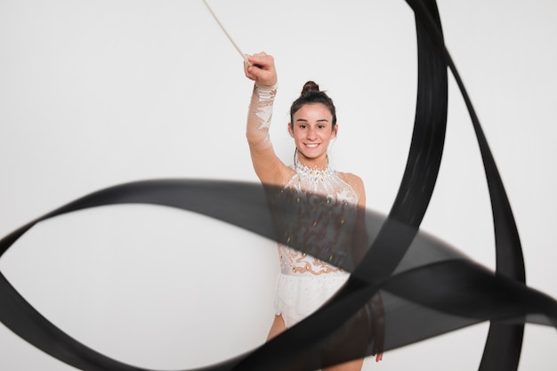 Rythmic gymnast posing with the ribbon