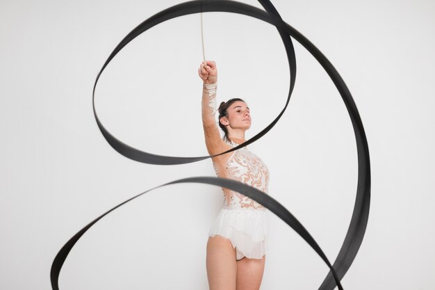 Rythmic gymnast posing with the ribbon