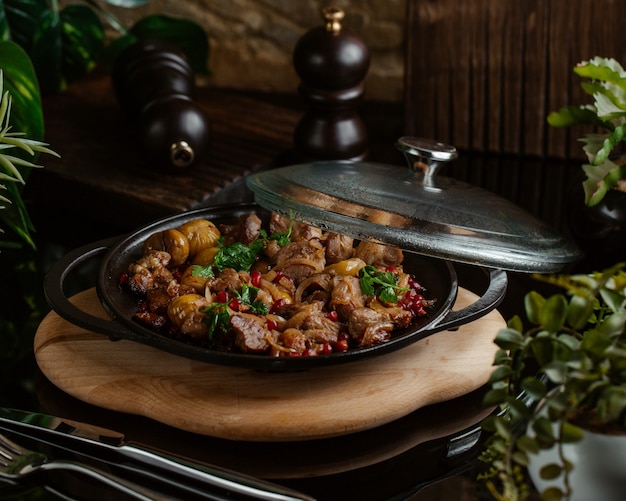 Sac qovurmasi, traditional food with mixed ingredients on a bamboo board