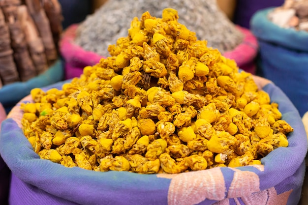 Sack with dried yellow flowers to sell in street market